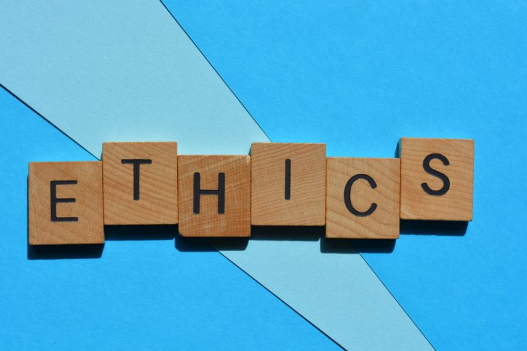 Ethics, word in wooden alphabet letters isolated on background as banner headline